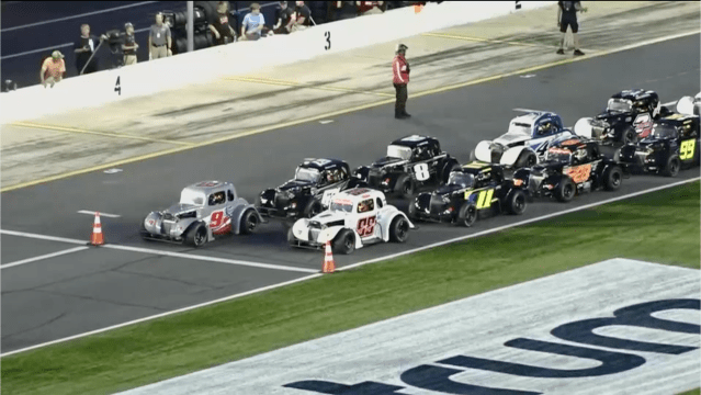 Legends cars lined up at the starting line at Charlotte Motor Speedway 
