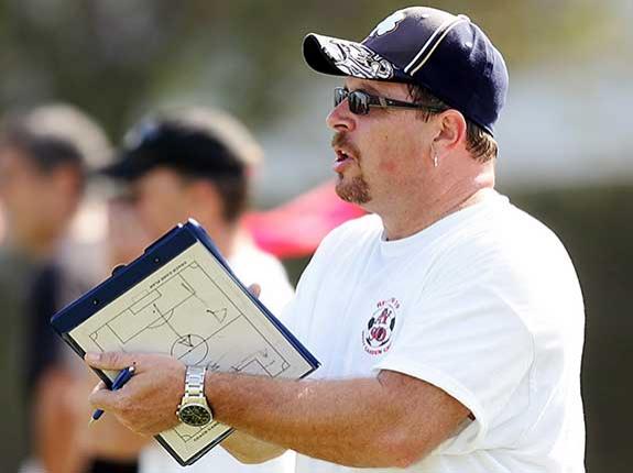 Coach holding a clipboard