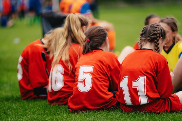 Girls in sports soccer team outdoors.