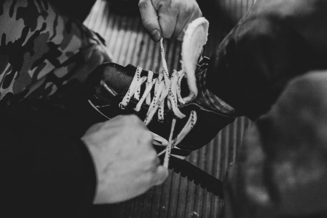 Parent tying child's hockey skates
