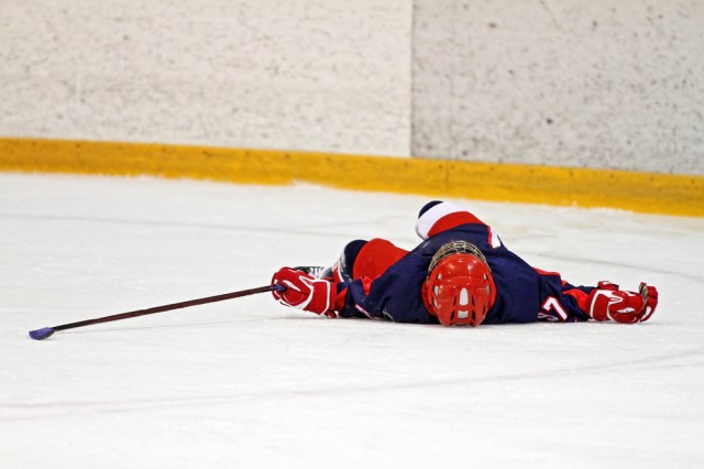 A hockey player may have a concussion after a check from an opposing player.