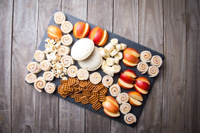 Fun kids snack tray with pretzels, fruit, sandwich rolls and more
