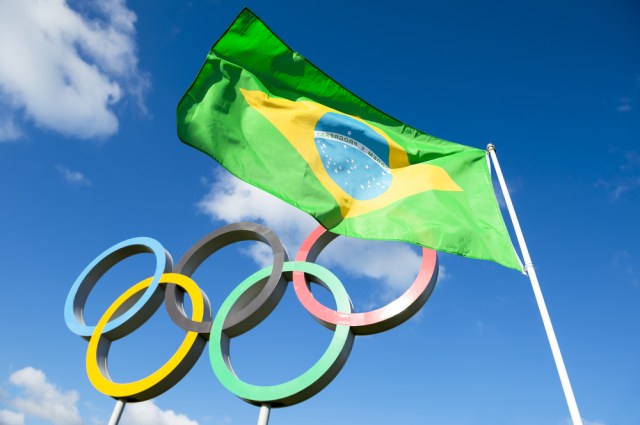 Brazilian flag flies next to the Olympic rings