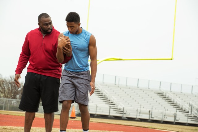 Youth football athlete with kid