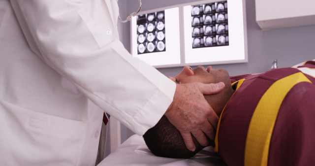 Portrait of senior chiropractor consult sports athlete's neck injury.