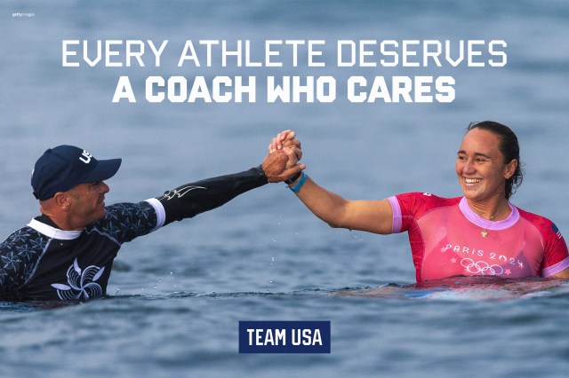 Coach and athlete high five in water